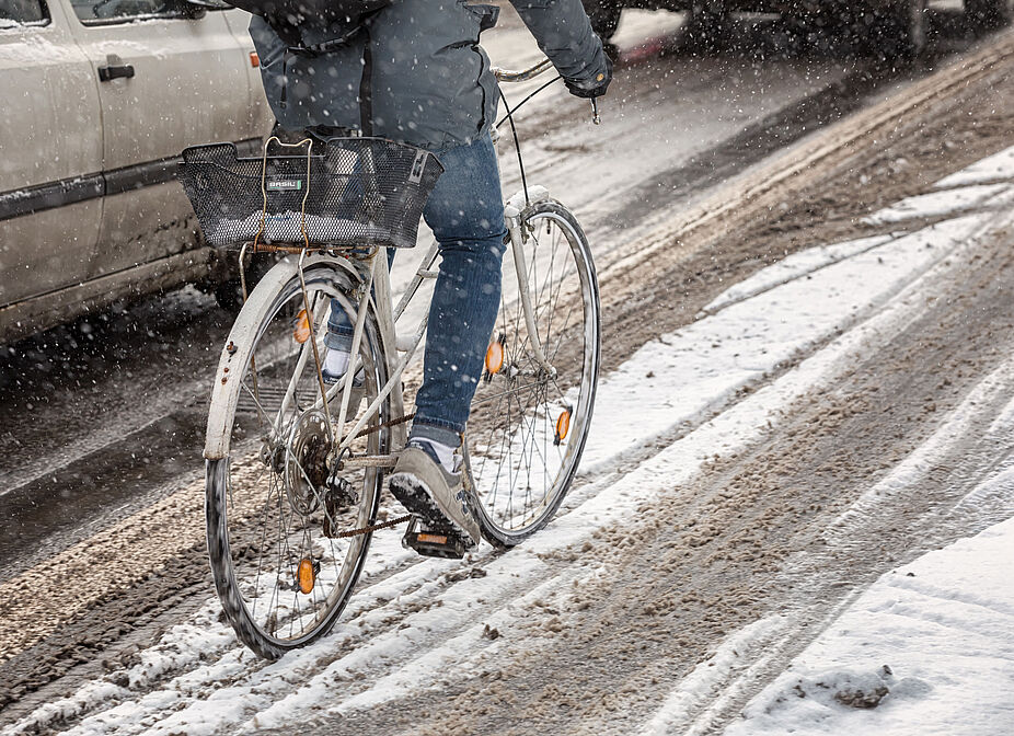 Schlecht gepflegte Wege für Radfahrende bringen Sturzgefahr - besonders im Winter Radfahrer im Schnee im Straßenverkehr